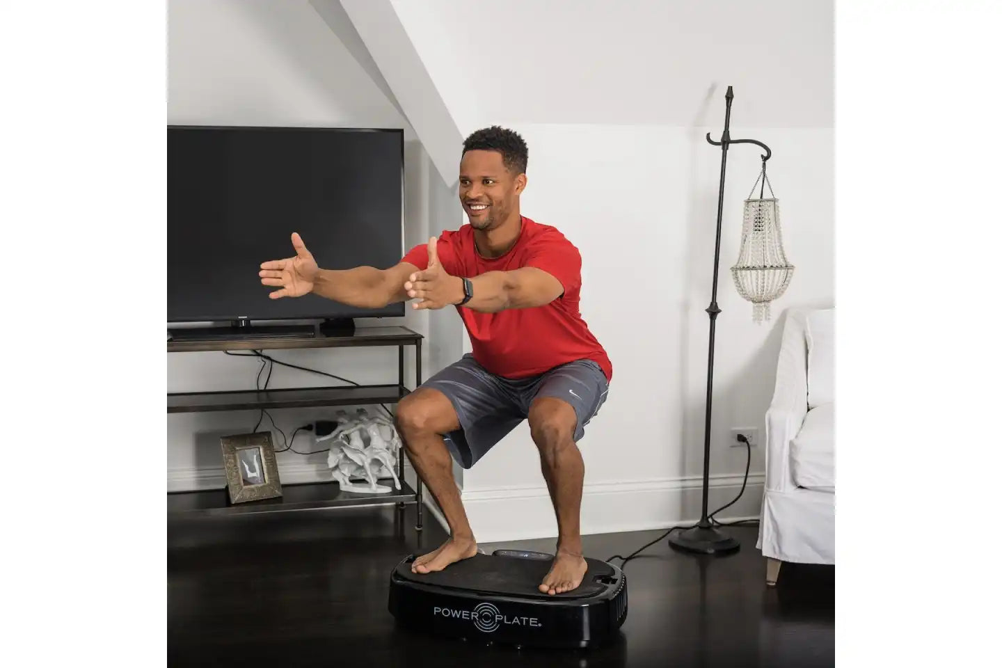 Man enjoying using the Personal Power Plate Vibration Plate