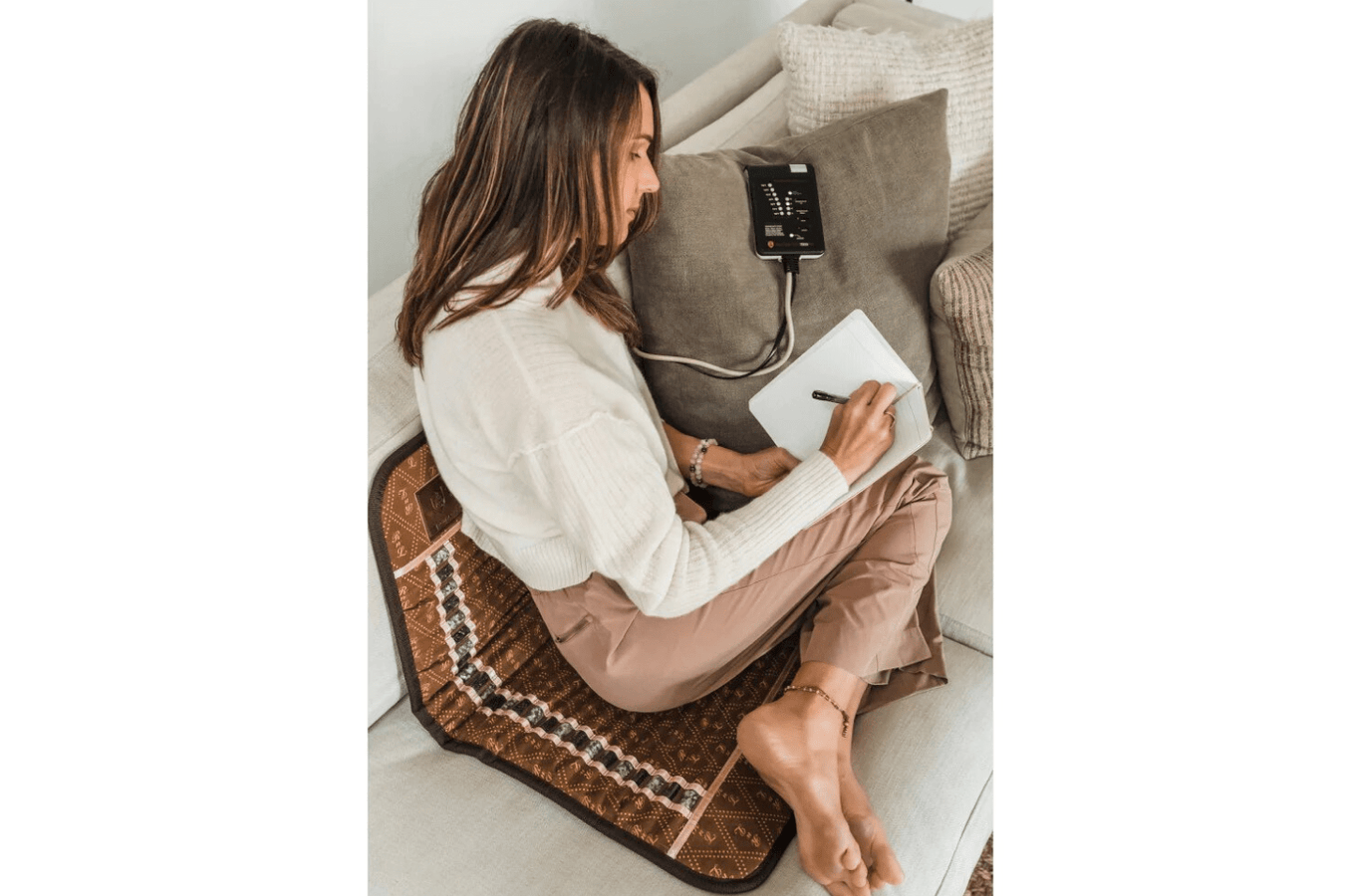 Mini Biomat 7000MX being used by a woman on the couch