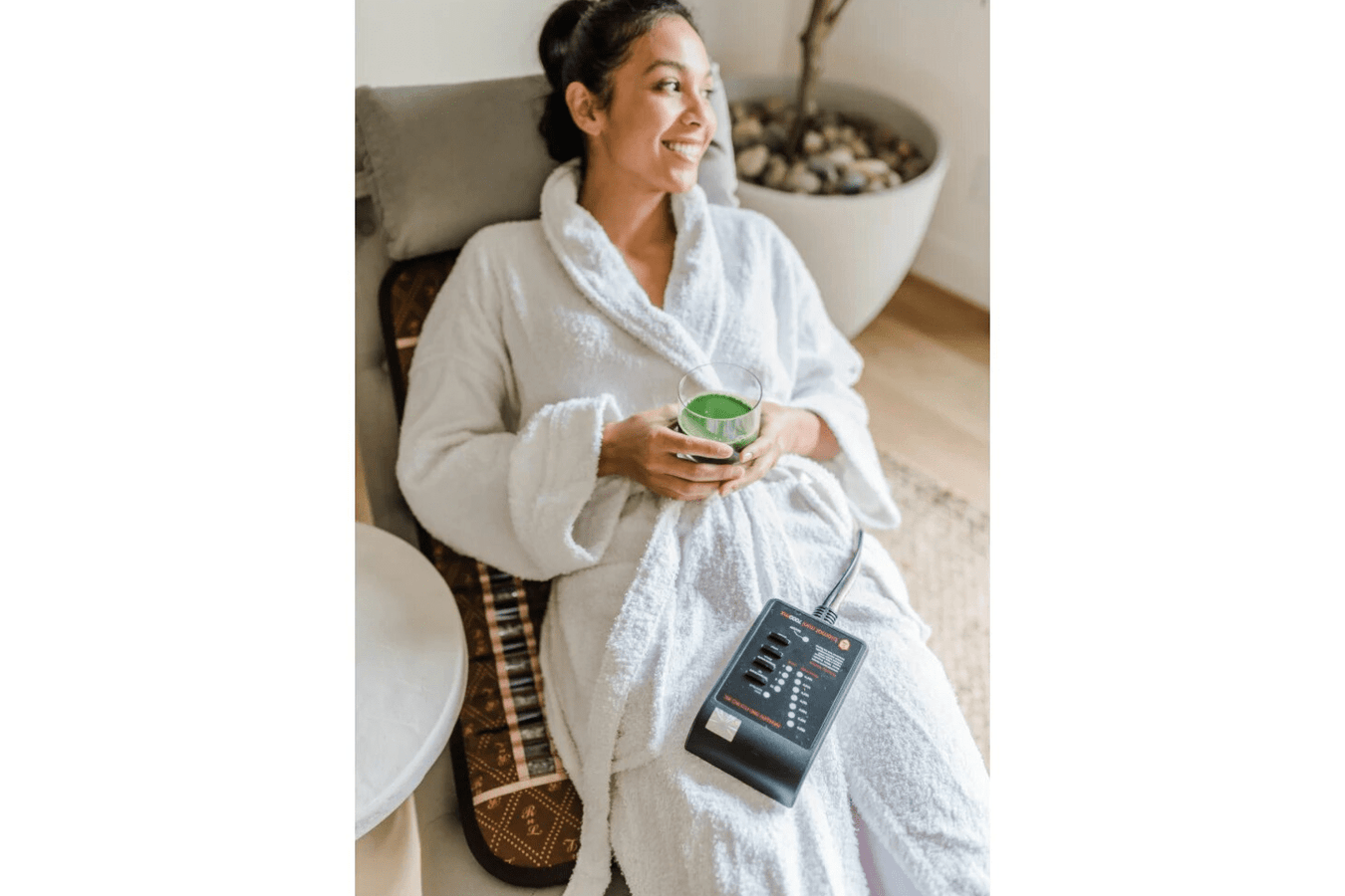 Biomat Mini 7000MX Infrared Mat being used by a woman in the living room