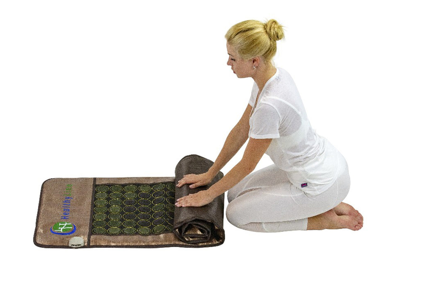 Person folding the Gemstone Heat Therapy Mat By Healthyline