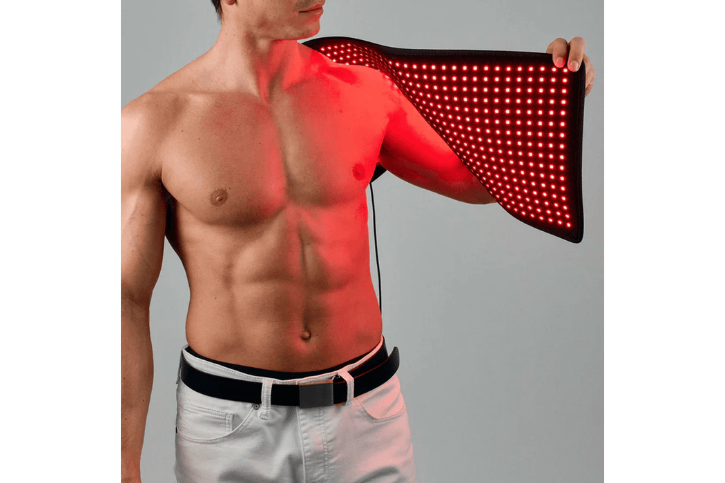 a man using the Lumara Red Light Therapy Pad on his shoulder