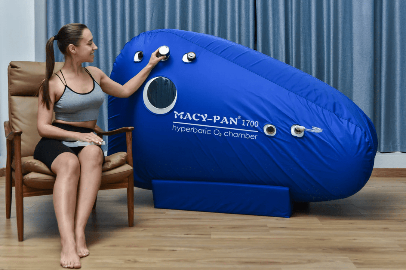 Person checking the pressure gauge of Macy Pan Seated Hyperbaric Chamber