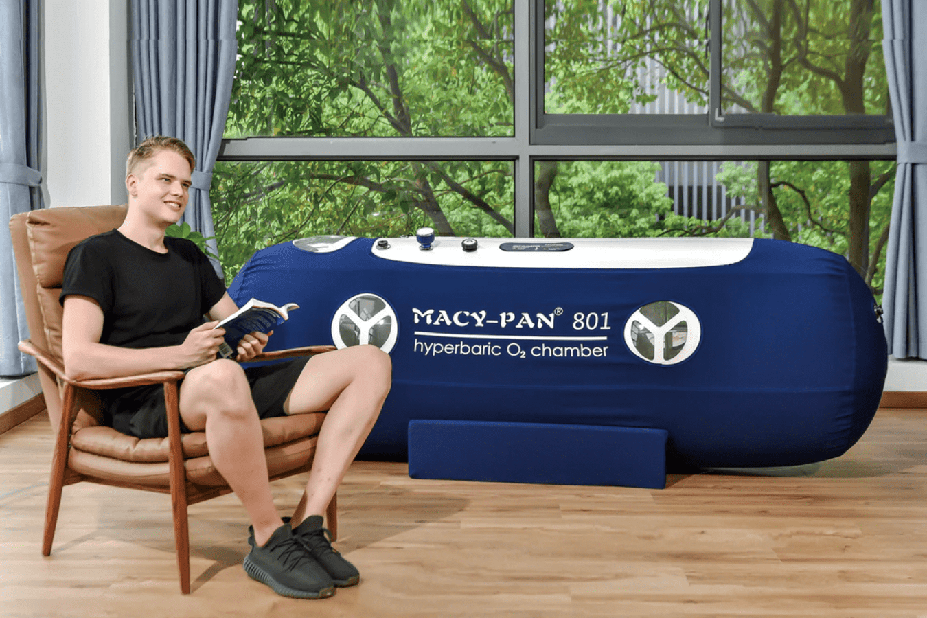 Person beside the Macy Pan Portable Hyperbaric Chamber
