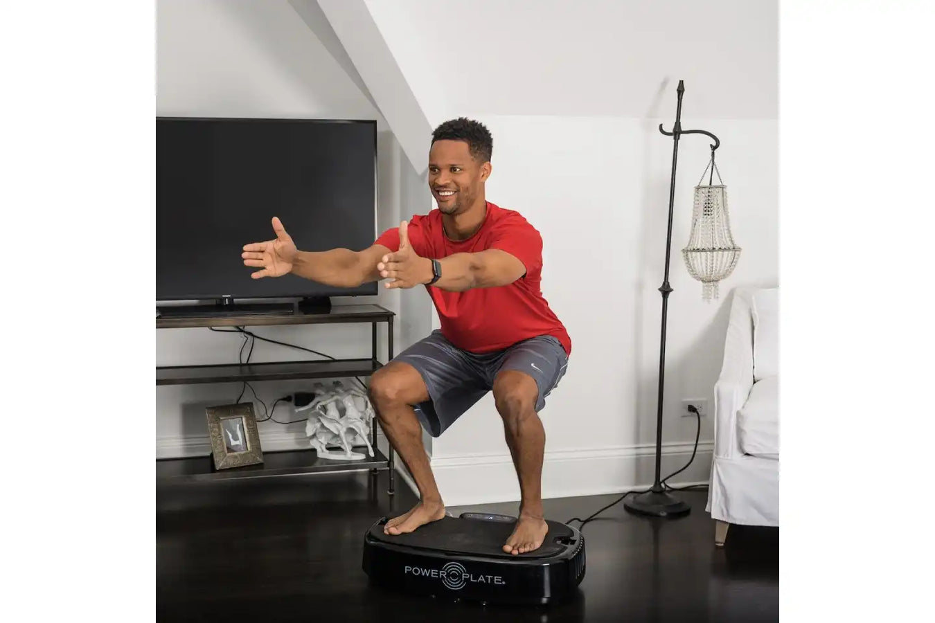 Man enjoying using the Personal Power Plate Vibration Plate
