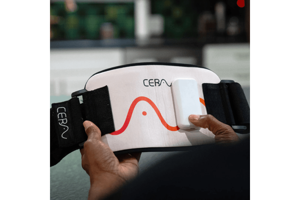 The CERA System Brain & Gut Red Light Therapy Device holding it