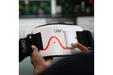 The CERA System Brain & Gut Red Light Therapy Device holding it