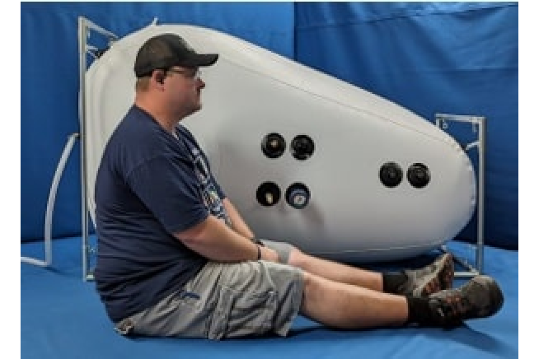 An adult male person perfectly fits the size of Newtowne Class 4 Hyperbaric Chamber