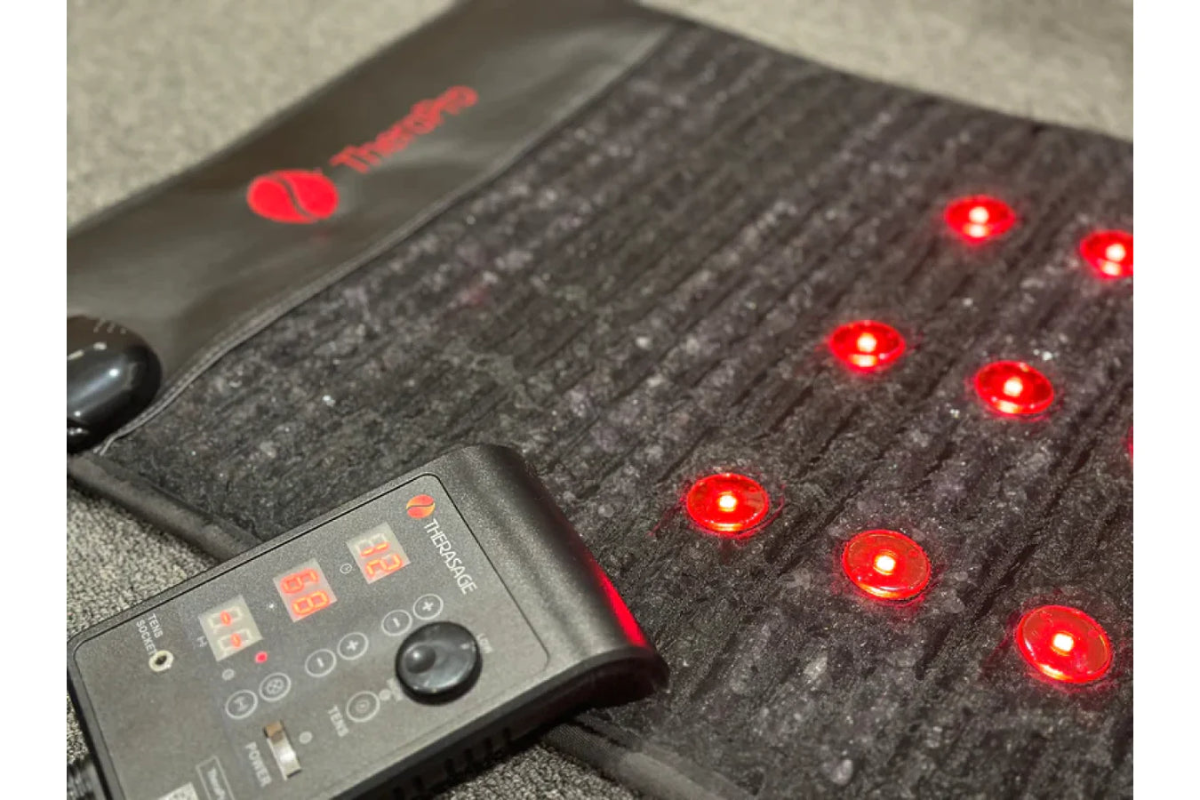 Therasage Red Light Therapy Pad with controller on the surface