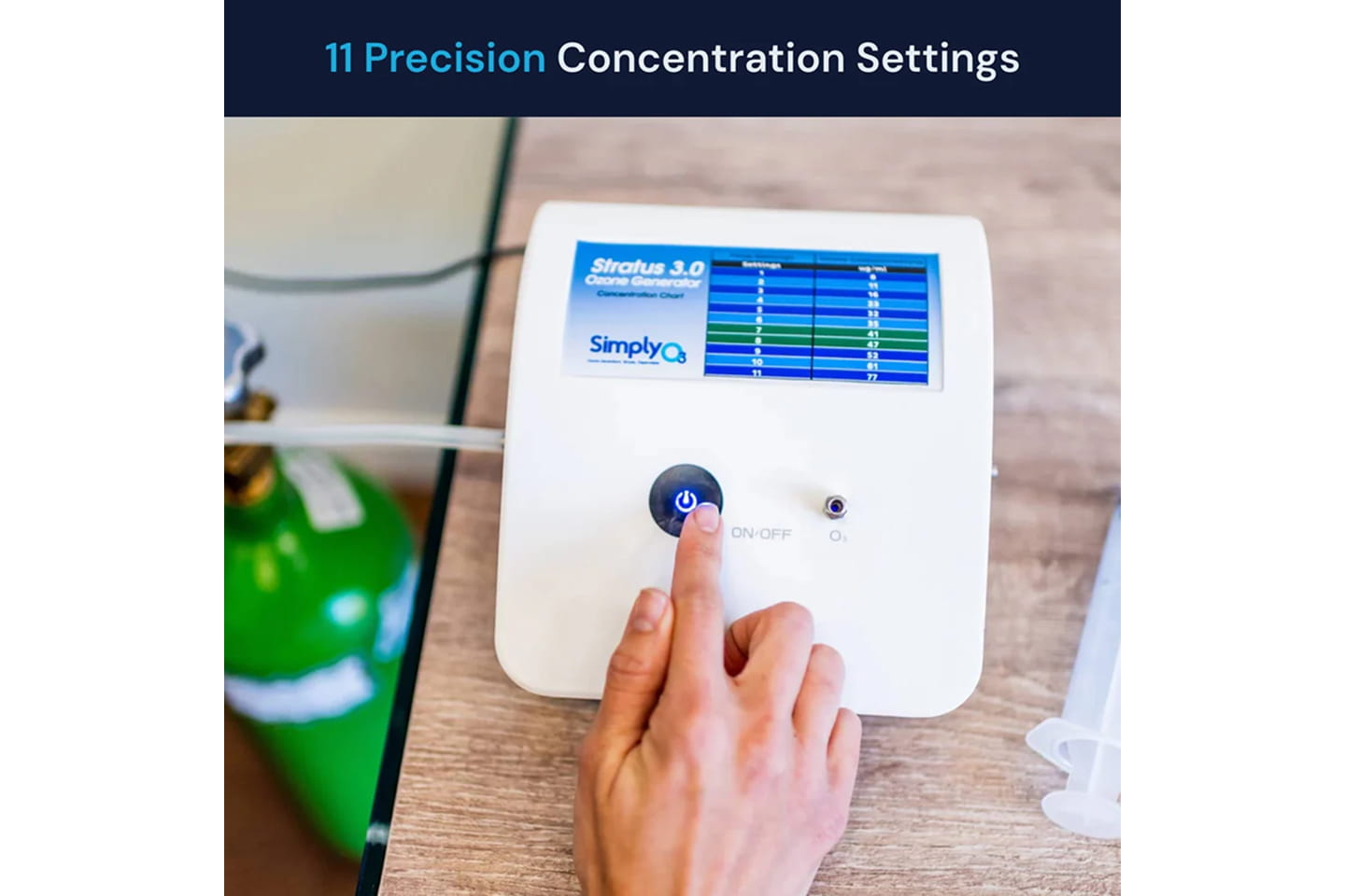 Close-up of the Stratus 3.0 ozone generator display showing 11 precision concentration settings, next to an oxygen tank