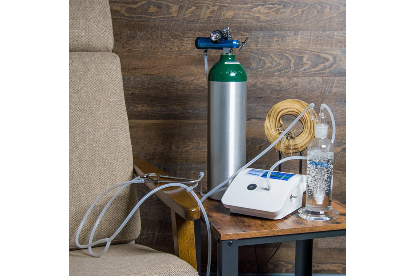 Stratus 3.0 Complete Kit set up beside an armchair, including the oxygen tank, ozone generator, and water bubbler system