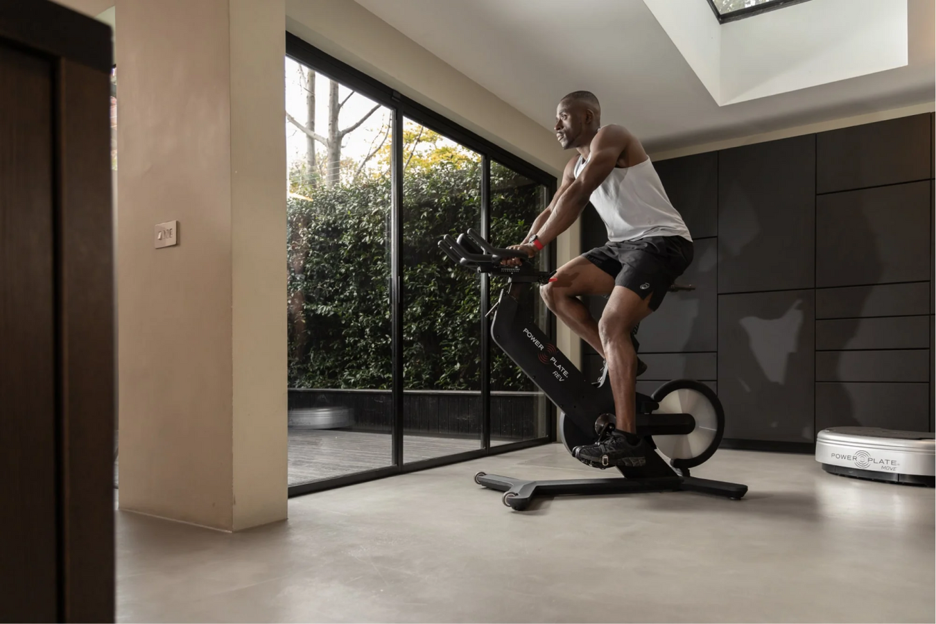 A man enjoying exercise on Power Plate REV™ Spinning Bike