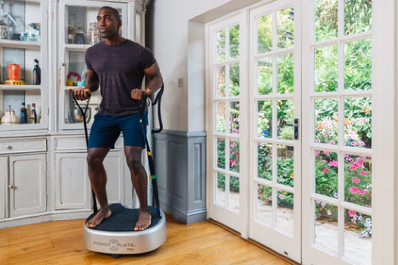 Man using the two straps of Power Plate Vibration Plate