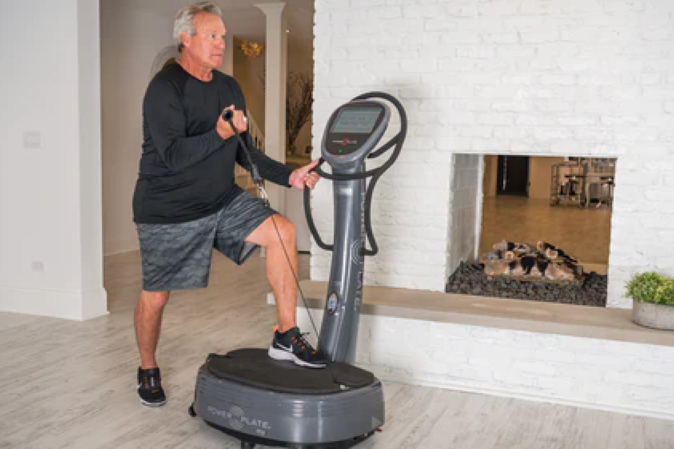 Person using the strap in the Power Plate Machine