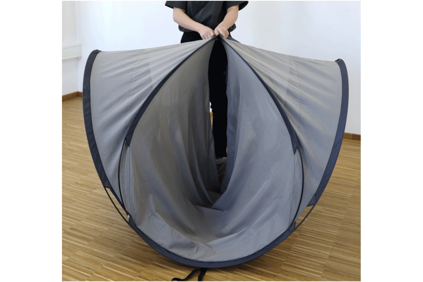 Person folding a YSHIELD® SAFECAVE Radiation Tent