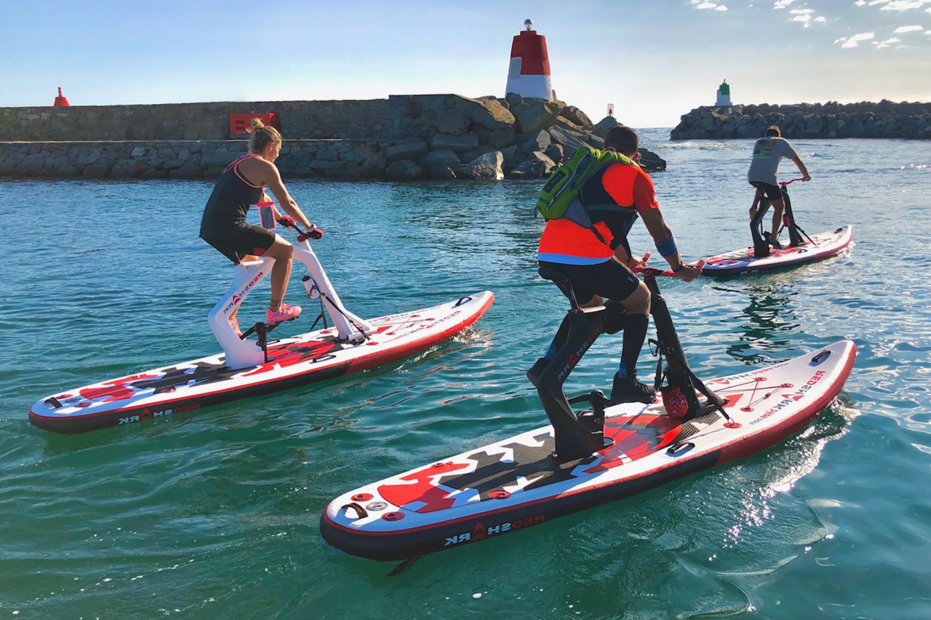 People using the Red Shark Water Bicycle on the water