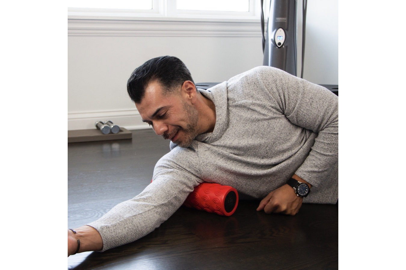 Person using the Power Plate Massage Roller on the floor